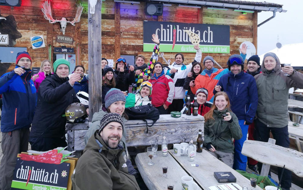 group photo of people in front of chilihütta ski lodge