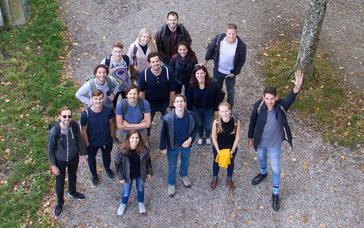 photo of people smiling into the camera from above