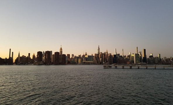 New York City Sky Line at sunset across body of water